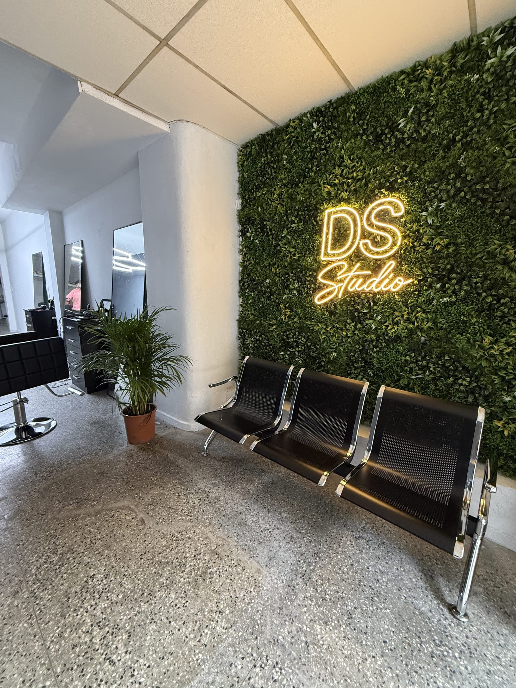 Sala de espera de DS STUDIO Montevideo con el cartel de neón